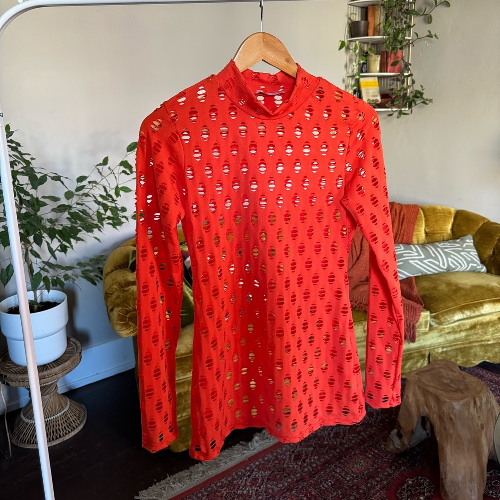 Statement vibrant orange perforated and textured mock neck long sleeve layering